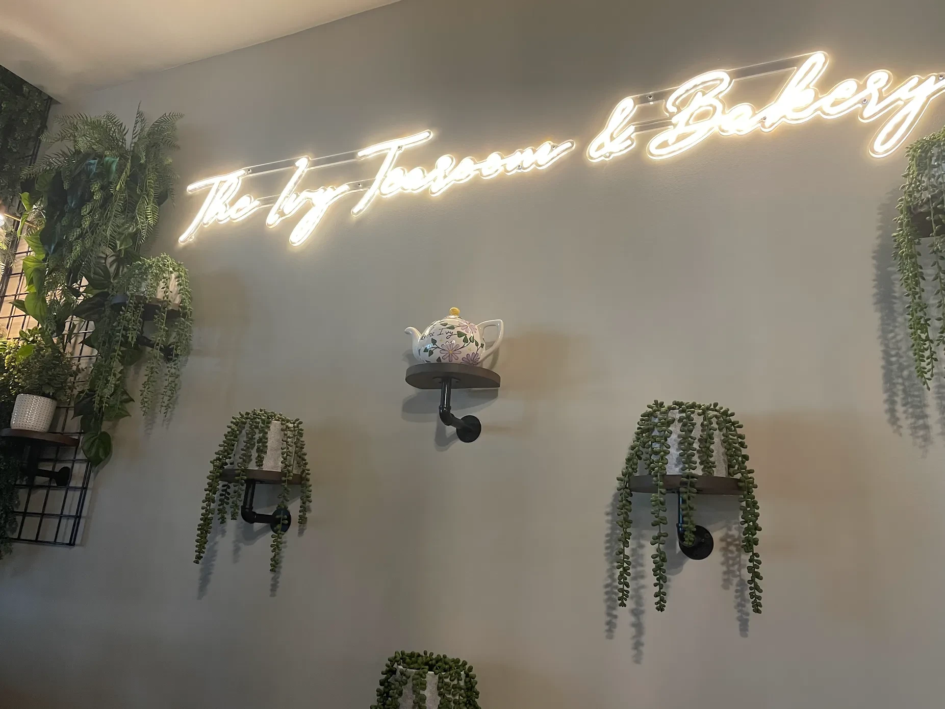 The Ivy Tearoom & Bakery neon sign with botanical décor